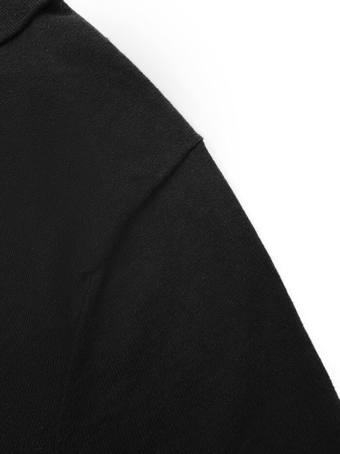 Dettaglio spalla di camicia nera elegante, tessuto morbido e cuciture precise.