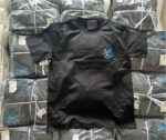 Maglietta nera con logo blu, confezionata in pacchi ordinati, perfetta per moda casual e retail.