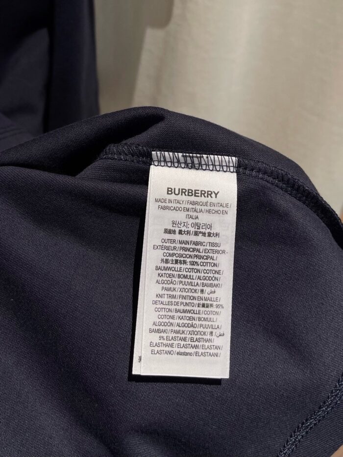 Etichetta Burberry con istruzioni di cura su abbigliamento nero di alta qualità.