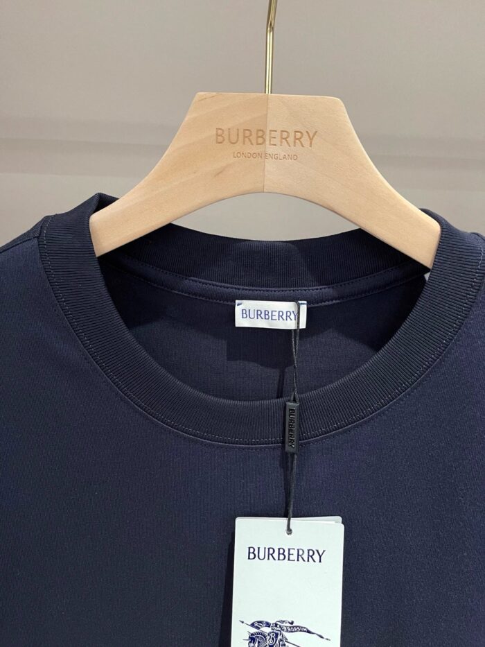 Felpa navy blue Burberry su appendiabiti di legno con etichetta e logo cavallo.