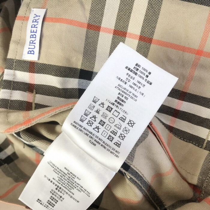 Camicia Burberry tartan con logo, etichette di cura e dettagli eleganti in stile luxury.