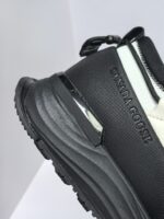 Sneaker donna Canada Goose nera e bianca, stile urbano, comfort, trazione e logo embossato.