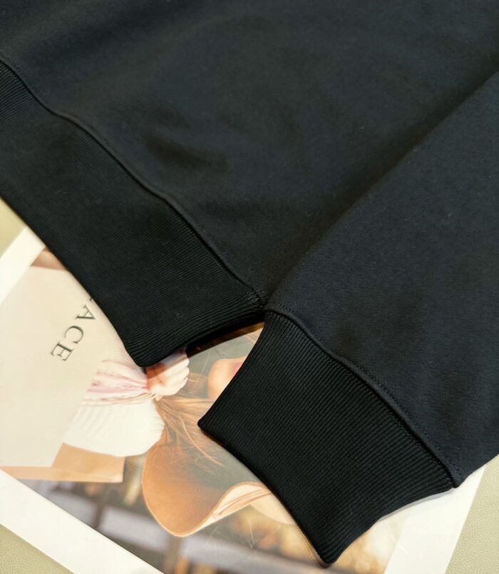 Maglia felpa nera casual con texture morbida, collo rotondo e polsini elasticizzati di alta qualità.