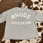 Maglietta oversize grigia RHUDE con stampa Côte d’Azur, stile streetwear casual e chic.