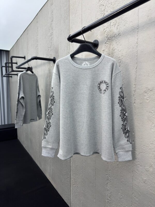 Felpa grigia casual con ricami floreali e logo frontale, stile moderno e versatile.