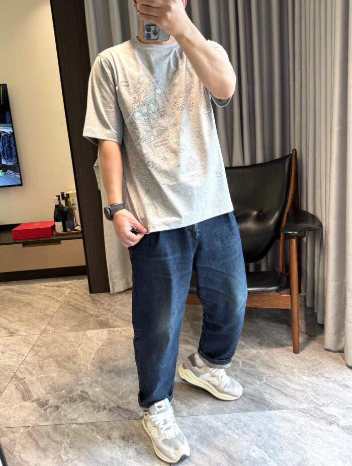 Uomo casual con jeans e sneakers bianche in un ambiente moderno e luminoso.