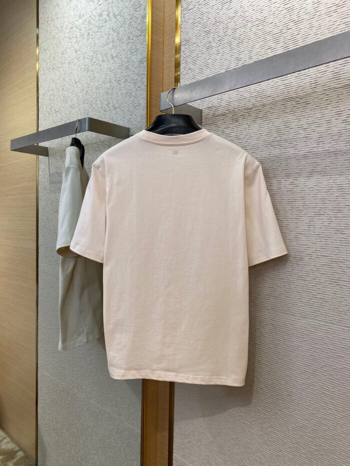 Maglietta casual pastello su supporto elegante in ambiente moderno e sofisticato.