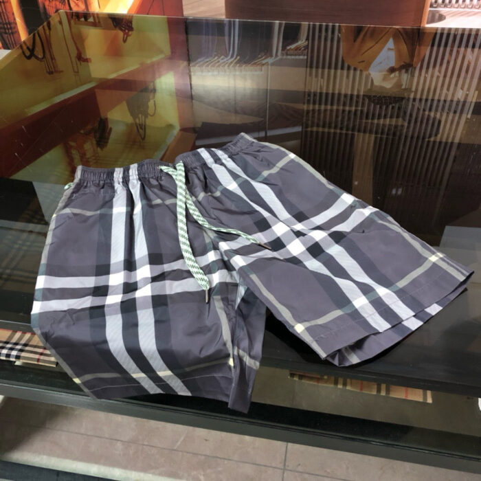 Pantaloncini eleganti in tartan grigio con coulisse verde acqua, perfetti per lestate casual.