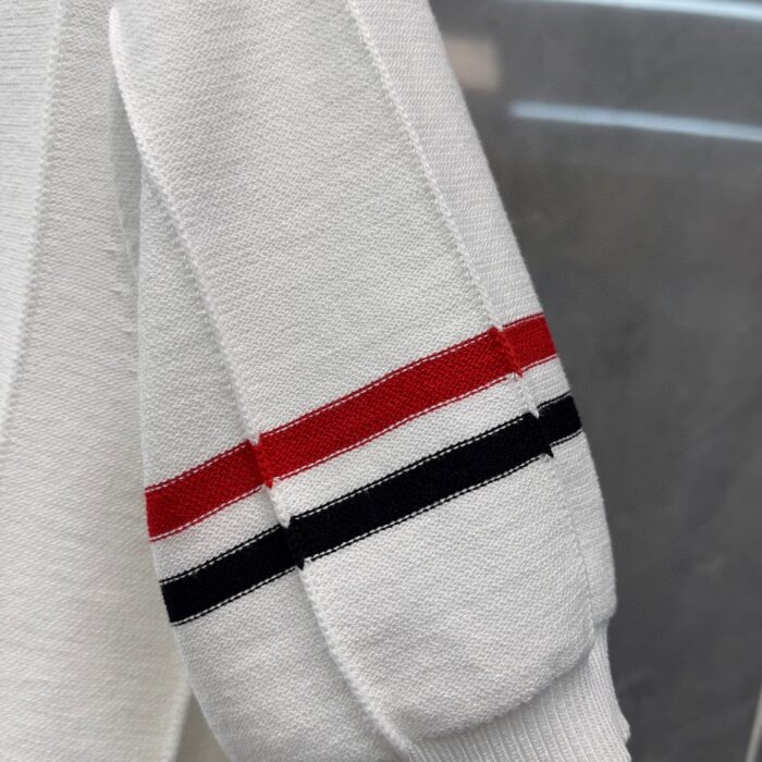 Felpa bianca casual con strisce rosse, bianche e nere, stile sportivo e comodo.