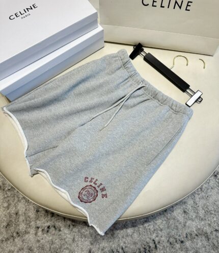 Shorts grigi CELINE con logo, dettaglio raw hem, stile casual di alta moda.