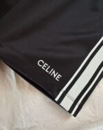 Shorts neri CELINE con logo bianco e strisce laterali sportive eleganti.