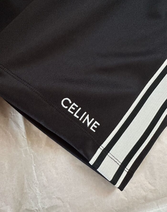 Shorts neri CELINE con logo bianco e strisce laterali sportive eleganti.