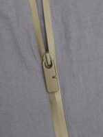 Chiusura lampo elegante e semplice su tessuto morbido, con dettagli precisi e funzionali.