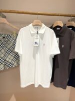 Esposizione di polo bianche e scure con pantaloncini a quadri in stile casual estivo.