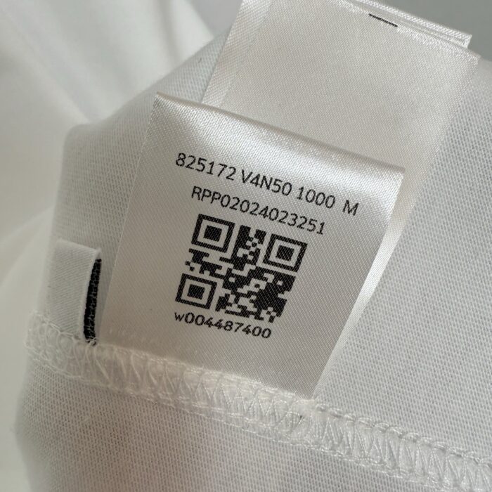 Etichetta tessuto con QR, codice a barre e dettagli prodotto per moda elegante.