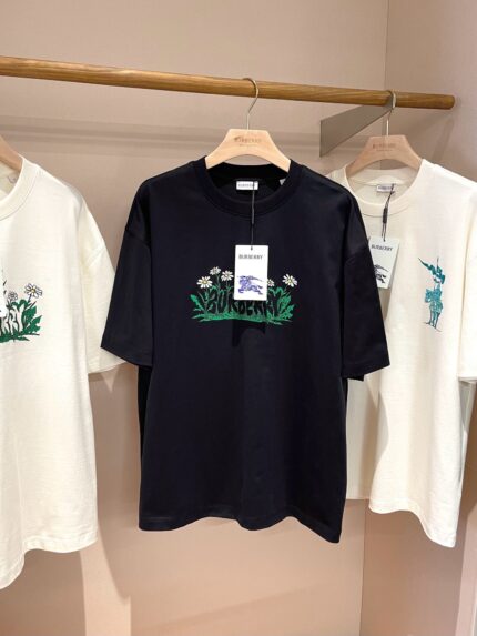 Esposizione di T-shirt con ricami, grafiche colorate e stile moderno in negozio.