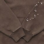 Felpa marrone con stelle decorative e polsini a coste, stile casual e originale.