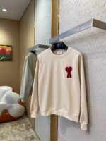Maglione casual crema con cuore rosso decorativo, ideale per comfort e stile giovane.