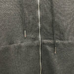 Felpa grigia con zip, tessuto testurizzato, stile casual, comfort e design moderno.