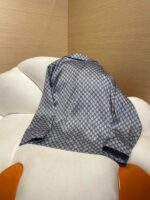 Sedia moderna con coperta lucida a motivo geometrico in ambiente elegante e confortevole.