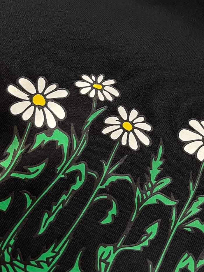 Disegno di margherite bianche su sfondo nero con foglie verdi e dettagli vivaci.
