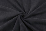 Tessuto nero velour in spirale, texture liscia, brillante ed elegante per moda e arredamento.
