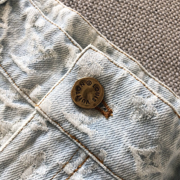 Dettaglio di bottoni in denim vintage con cuciture e texture in stile casual.