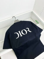 Maglietta nera Dior con logo bianco sul retro, stile streetwear di lusso.
