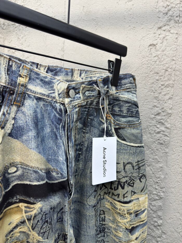 Jeans distressed con dettagli artistici, patch colorati e scritte graffiti, stile urbano e moderno.