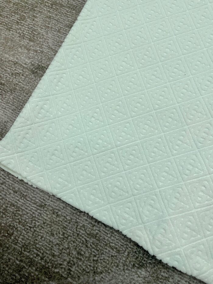Texture di tessuto verde menta e morbido tessile grigio in contrasto.