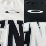 Magliette moderne bianco e nero con logo ricamato elegante e dettagli in rilievo.