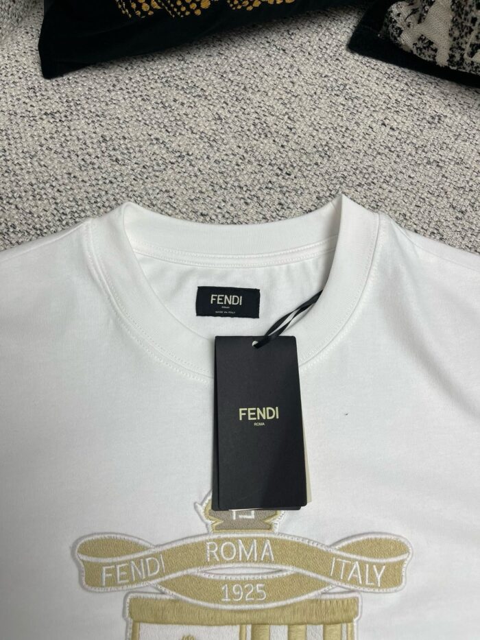 Maglietta bianca Fendi con logo dorato, dettagli eleganti e tag di autenticità.