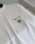 T-shirt bianca Fendi con tasca zip e logo nero, stile luxury minimalista e di tendenza.