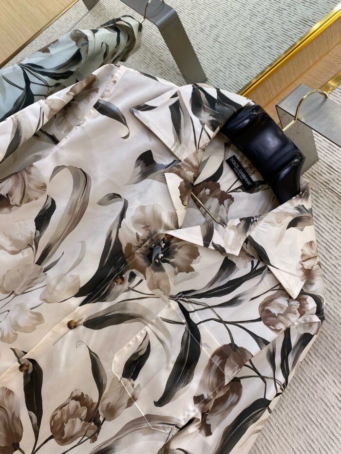 Camicia floreale in seta con design artistico di fiori marroni e foglie verdi, elegante e versatile.