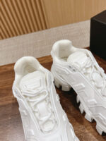 Sneakers bianche futuristiche con suola chunky, eleganti, ideali per stile casual e high fashion.