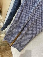 Pantaloni geometrici blu con gradiente, tessuto leggero e stile versatile per ogni occasione.