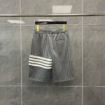 Pantaloncini sportivi grigi con strisce bianche, comfort e stile casuale.