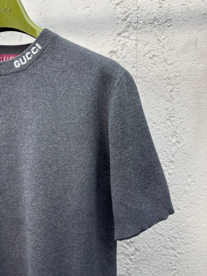 Maglietta grigia oversize Gucci con logo bianco, stile casual e look di lusso moderni.