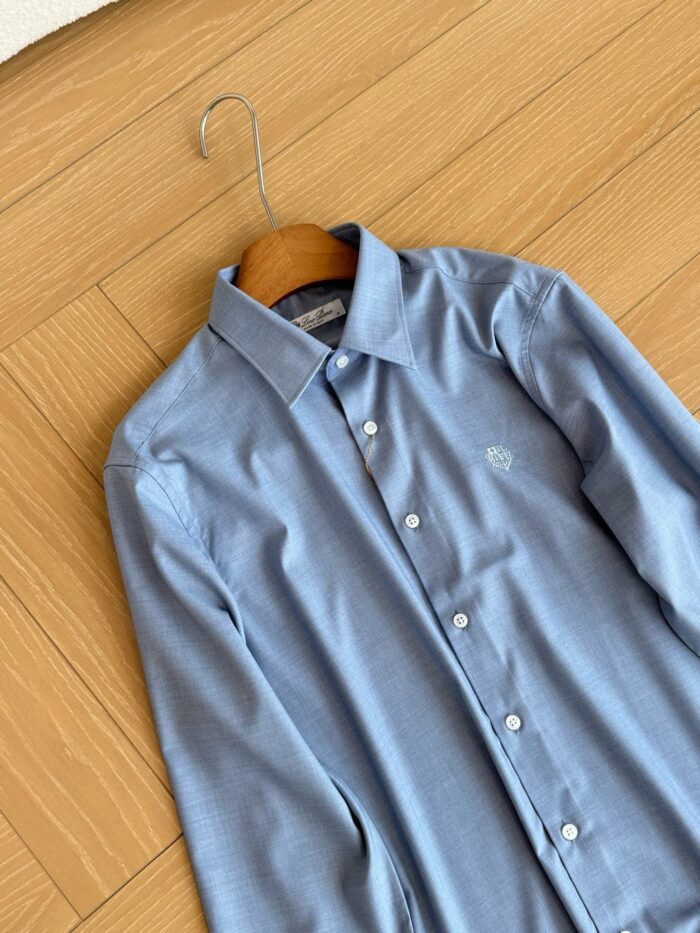 Camicia uomo blu chiaro elegante su appendiabiti in legno, stile formale e raffinato