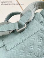 Borsa in pelle azzurro chiaro, design strutturato, manici moderni e dettaglio branding elegante.