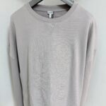 Felpa grigia Loewe con logo embossing e dettagli artistici, stile casual e sofisticato.