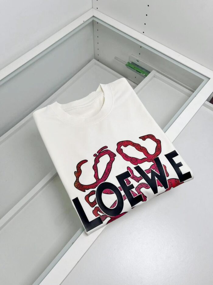 T-shirt bianco Loewe con grafica artistica e logo moderno, elegante display in vetro.