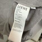 Etichetta LOEWE di lusso con dettagli su materiali, cura e origine italiana.