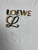 Maglietta LOEWE con logo colorato, dettagli ricamati e design moderno su sfondo bianco.