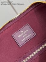 Interno di una borsa Louis Vuitton cosmetica in pelle Bordeaux, made in France con logo e zip dorati.