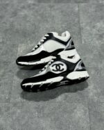 Sneaker di lusso neri e bianchi con logo Dior, stile moderno e design elegante.