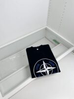 T-shirt nero Dior con logo moderno in vetrina minimalista di lusso.