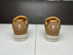 Sneakers di lusso marroni con logo iconico, design moderno e materiali di alta qualità.