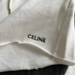 Etichetta Celine su maglione di lusso con dettagli sartoriali eleganti.