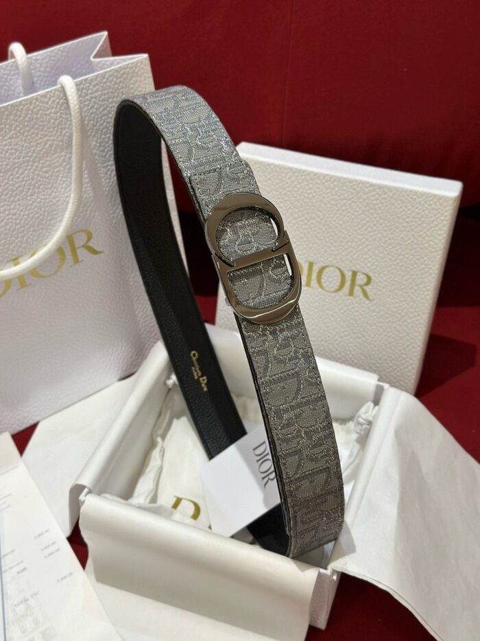 Cintura Dior grigia di lusso con fibbia argento, confezione elegante e stile sofisticato.